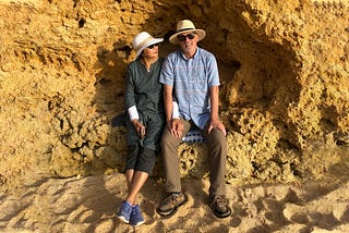 Couple sitting on a rocky beach