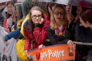 Harry Potter fans wait with umbrellas in the rain outside the cinema in Leicester Square, central London, for the world premiere of ‘Harry Potter and The Deathly Hallows: Part 2,’ the last film in the series, Thursday, July 7, 2011. (AP / Joel Ryan)
