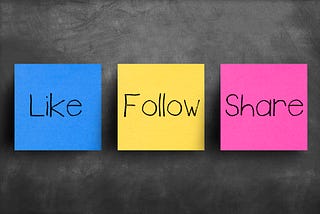 blue like, yellow follow and purple share post-it notes on black chalkboard