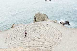 person walking on a beach during daytime