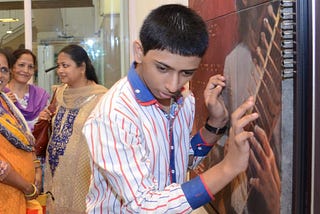 A visually impaired child feeling the painting by Chintamani Hasabnis