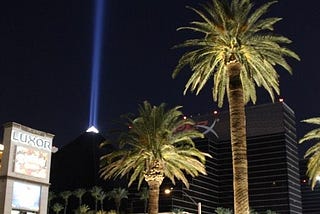 A nighttime photo of the Luxor Pyramid with its beam of light shining bright, straigt up into space, Las Vegas, Nevada