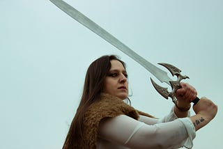 A young woman holding a sword above her head