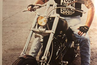 The author on a Harley Davidson motorcycle looking at the camera
