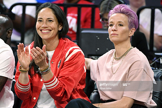 Sue Bird and Megan Rapinoe sit courtside at the WNBA All-Star Game.