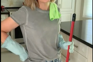 Janet Fanaki wearing rubber gloves is holding a mop getting ready to do one of her favourite things — deep clean the floors. She believes that cleaning is one of the unsung heroes for maintaining mental health.