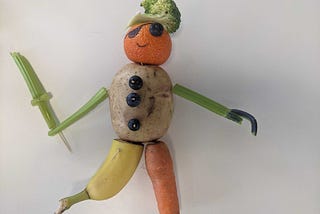 Sculpture of a pirate made out of fruit and vegetables.