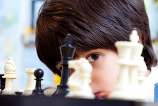 Young boy playing chess
