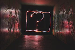 Photo of a question mark illuminated in neon lights
