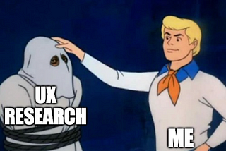 A meme of Fred from Scooby Doo labelled “Me” unveiling the mask of a character labelled “UX Research”