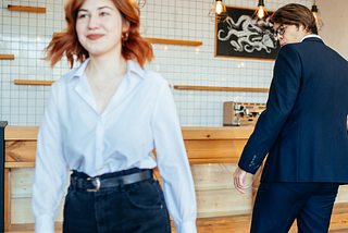 A man staring at a woman who looks happy.
