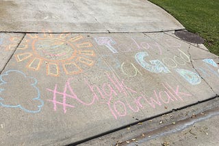 chalk art on sidewalk that reads today is a good day with smiling sun