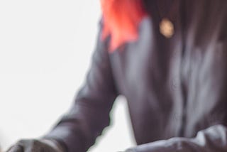 A disabled Asian genderfluid person types on a laptop while wearing compression gloves. The hands and keyboard are the focal point. https://affecttheverb.com/gallery/disabledandhere/arthritistyping/