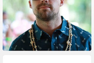 Dating app profile of man wearing large sunglasses and a blue collared shirt