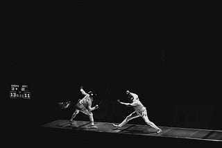 Two people fencing.