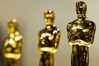 A line of golden Oscar statues.