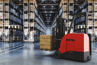 Autonomous forklift carrying pallets in a warehouse.