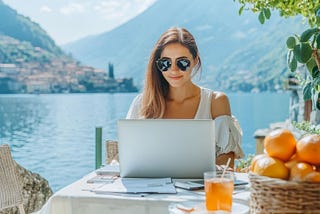 Freelance woman working by lake como remote digital nomad enjoying scenic view in Italy