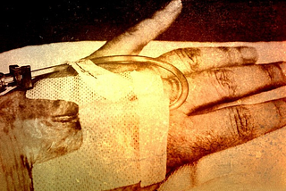 IV tube running into a vein, taped up to the hand