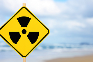 A sign on a beach boasting a radioactive symbol