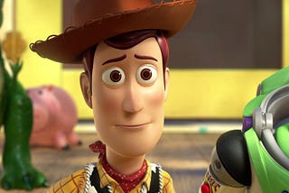 Woody, Buzz, and several other toys solemnly watch Andy leave in ‘Toy Story 3’.