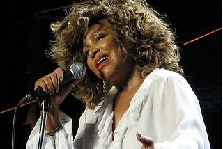 Tina Turner singing into a microphone