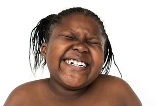 Young girl in the midst of a big laugh