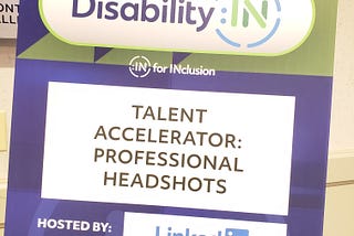 Purple and Green Standee Board that read’s “Disability:In, In for Inclusion, Talent Accelerator: Professional Headshots, Hosted by: Linkedin.”