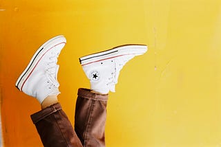 A photo of Converse sneakers and a yellow background