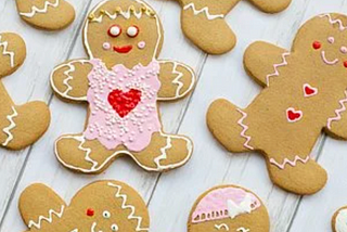 An array of iced gingerbread people on a gray background