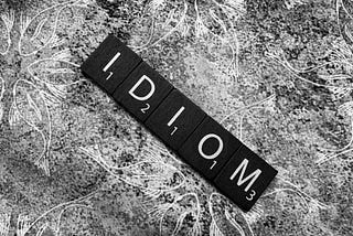 A black-and-white picture of hte word idiom in Scrabble letters