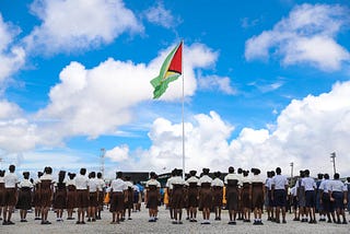 Students stood attentively as the Golden Arrowhead was raised in 2019 (DPI photo)