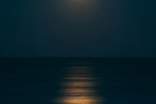 By now the moon had risen over the sea