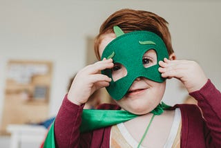 Small child in a superhero costume