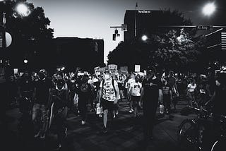 Black and white photo of a crowd at part of a peaceful racial justice protest.