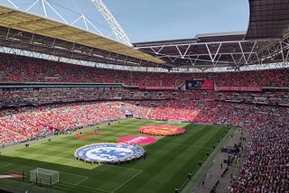 The scene at Wembley just before the teams emerged. The stadium is about three quarters full and the red carpet has been rolled out on the pitch along with two large Chelsea and Manchester United crests and the tournament sponsor’s logo.