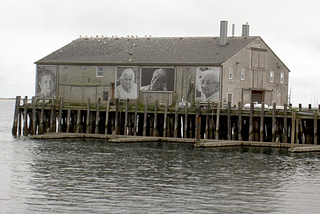 A fishing shed in Provincetown with four giant pictures of Portuguese American women on the wall