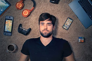 Thomas J Frank YouTuber lying on the floor with multiple devices showing Notion Templates.