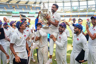 Mumbai’s Dhawal Kulkarni lifts the championship trophy after winning the Ranji Trophy final test cricket match between Mumbai and Vidarbha as he played his last match, at the Wankhede Stadium, in Mumbai, Thursday, March 14, 2024.