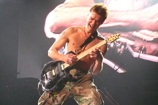 Eddie Van Halen playing guitar onstage