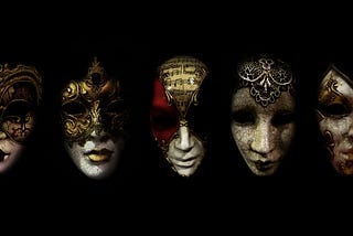 5 Venetian masks in a row in front of a black backdrop