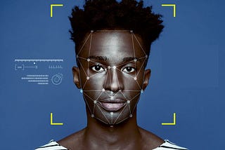 A dark-skinned person stares directly at the screen with facial recognition mapping points symmetrically placed around their face.