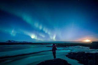 Person taking in outdoor view at night