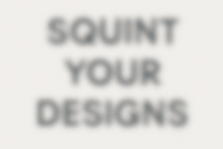 A blurred graphic with the phrase “SQUINT YOUR DESIGNS” in large, bold text. The words are barely readable due to the soft blur, simulating the effect of squinting.