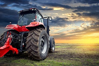 Tractor driving into the sunset.