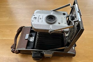 The Polaroid “Land” Camera was the first “instant” camera, but you had to peel your finished photo out of the back.