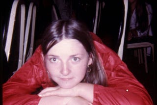 Photograph of Ann McIlhargey lying on chairs in the ballroom of the Silver Springs Maryland Holiday Inn sometime in May of 1972.