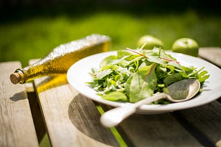 A plate of food outside on a table