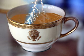 An image of a porcelain Woodrow Wilson teacup depicting lightning entering the tea inside the cup, relating to the saying - Storm in a tea-cup