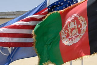 United States, Afghanistan and NATO flags flyign side by side